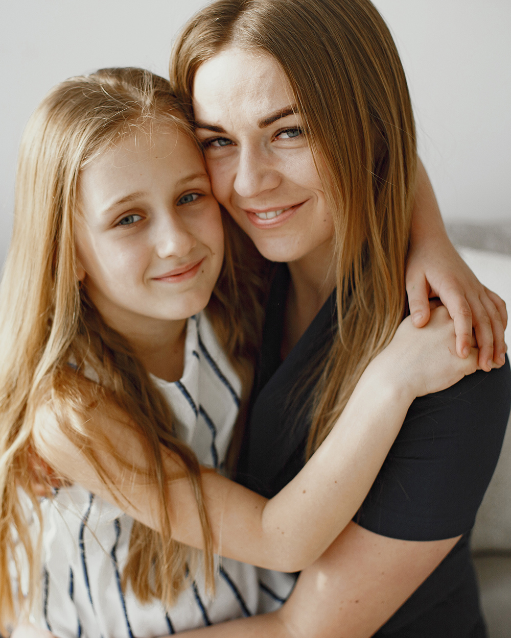Happy mother and daughter embracing, showing the supportive relationship between family members managing health together